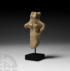 Greek Cypriot Female Idol 7th-5th century B.C. A ceramic female idol modelled with figurative anatomical detailing, standing with one hand resting on ...