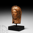 Graeco-Italic Terracotta Bust Circa 4th-2nd century B.C. A mould-made terracotta female bust modelled in raised relief with semi-naturalistic facial f...