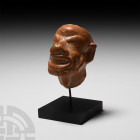 Hellenistic Terracotta Grotesque Mask 3rd-1st century B.C. A terracotta mask modelled as a grotesque male face with exaggerated bushy eyebrows above b...