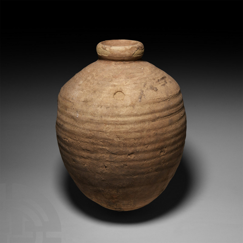 Roman Ribbed Amphora 1st-2nd century A.D. or later. A squat ceramic jar with tap...