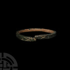 Roman Bracelet with Snake-Head Terminals 1st-3rd century A.D. A zoomorphic bracelet composed of a rectangular-section hoop, stylised snake-head termin...