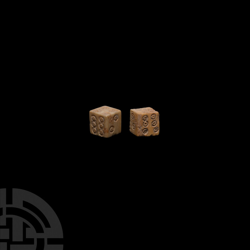 Roman Bone Dice Pair 1st-4th century A.D. A pair of bone dice with punched ring-...