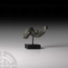Roman Schist Dolphin 1st-2nd century A.D. A carved schist dolphin figure with stylised detailing to the fins and face; mounted on a custom-made displa...