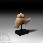 Roman Marble Dolphin and Foot Section 1st century B.C.-2nd century A.D. A stylised marble dolphin statue fragment with shallow circular eyes, a sandal...