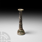 Roman Candlestick Unguentarium 1st-3rd century A.D. A glass candlestick unguentarium composed of a bell-shaped lower body, tall cylindrical neck decor...