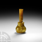 Byzantine Golden Iridescent Glass Flask 6th-8th century A.D. A gold-green coloured glass bottle with globular body, cylindrical stepped shoulder and s...