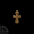 Byzantine Bone Cross Pendant 10th-12th century A.D. A carved bone cruciform pendant with incised figure of Christ in the orans pose with hands palm-up...