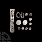 Byzantine Silver Belt Fitting Group Circa 7th century A.D. A mixed group of silver belt fittings comprising: eight small discoid studs with slender mo...