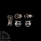 Byzantine Silver Belt Fitting Group 7th century A.D. A group of silver belt fittings comprising: two mounts with one domed and one straight edge, deco...