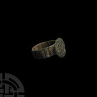 Byzantine Ring with Waves 10th-13th century A.D. A bronze ring composed of a deep hoop and oval-shaped bezel engraved with vertical plain and snaking ...