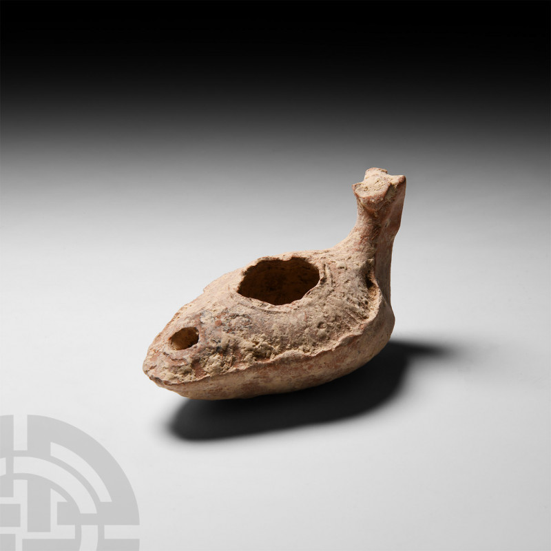 Byzantine Animal-Headed Lamp 6th-7th century A.D. A slipper-shaped ceramic oil l...