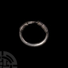 Western Asiatic Silver Bracelet 1st millennium B.C. A heavy silver bracelet composed of a tapering round-section hoop overlapping at the terminals, fo...