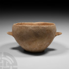 Bronze Age Jar with Loop Handles 2nd-1st millennium B.C. A broad cream-coloured ceramic bowl with two ledge handles, slightly inverted rim with pourin...