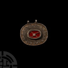 Bedouin Silver Pendant 19th-20th century A.D. A silver oval-shaped pendant with raised central cell with red inlay overlaid with applied twisted wire ...