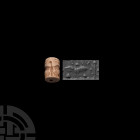 Mesopotamian Cylinder Seal with Bird 3rd millennium B.C. A frit cylinder seal with a large bird with its wings spread and legs splayed, symbols to the...
