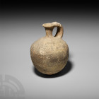 Large Tell Yaduea Ware Grey Juglet 3rd millennium B.C. A grey juglet with piriform body, trumpet-style neck and mouth, m-section handle and small disc...