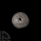 Spindle Whorl 12th-6th century B.C. A grey stone spindle whorl of domed form. 6 grams, 24 mm (1 in.). Acquired in Jerusalem, Israel, in the 1980s. Fro...