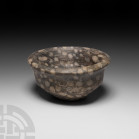 Bactrian Grey and White Stone Bowl 2nd millennium B.C. A grey and white stone bowl with carinated body and bevelled rim. 260 grams, 88 mm wide (3 3/8 ...