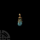Gold Pendant with Turquoise 1st millennium A.D. An openwork net-style gold cap with granulated flange and suspension loop, with later piriform turquoi...