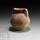 Terracotta Amphora 3rd millennium B.C. A terracotta jar with piriform body, flared neck, everted rim and two lentoid-section strap handles. 1.4 kg, 19...