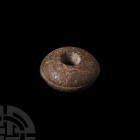 Spindle Whorl Iron Age I, 12th-11th century B.C. A stone spindle whorl with domed profile, incised line around the rim. 7.5 grams, 25 mm (1 in.). Acqu...