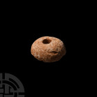 White Limestone Spindle Whorl Bronze Age, 3200-1200 B.C. A white limestone(?) plano-convex spindle whorl with central hole. 5.41 grams, 24 mm (1 in.)....