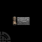 Mesopotamian Cylinder Seal with Advancing Figures 3rd-2nd millennium B.C. A steatite cylinder seal with a pair of advancing figures with their arm rai...