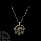 Amlash Horse Harness with Chrismon Pendant 1st millennium B.C. A bronze horse harness pendant, formed as an openwork circle with the edge decorated wi...
