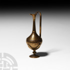 Western Asiatic Gold Inlaid Ewer 20th century A.D. A bronze ewer composed of a carinated body, slender neck, V-section spout and handle, seated amidst...
