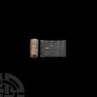 Babylonian Cylinder Seal with Worshipping Scene Early 2nd millennium B.C. A stone cylinder seal with an adoration scene comprising a pair of worshippe...