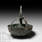 Western Asiatic Decorated Cup with Cradle Late 2nd-mid 1st millennium B.C. A hemispherical copper-alloy cup decorated with two tiers of repoussé bulbs...