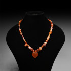 Carnelian Necklace with Heart-Shaped Pendant Circa 1st millennium B.C. A restrung necklace composed of graduated carnelian beads and central 'heart-sh...