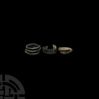 Bronze Age Ring Group 2nd millennium B.C. A group of three copper-alloy finger rings comprising: a coiled ring formed as a snake with simple detailing...