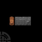 Western Asiatic Cylinder Seal with Worship Scene 3rd millennium B.C. A waisted cylindrical marble stamp seal bearing a worship scene composed of a pro...