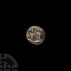 Aramaic Lead Sealing with Standing Figure 1st century B.C.-1st century A.D. A discoid lead seal with Greek text 'HEPWVOY' for 'of Heron' to obverse an...