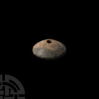 Western Asiatic Green Stone Spindle Whorl Bronze Age, 3200-1200 B.C. A polished green stone spindle whorl or jar-stopper, with a shallow conical body ...