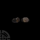 Western Asiatic Silver Calligraphic Signet Ring Dated 1165 A.H. (1751 A.D.). A silver finger ring with octagonal bezel, three lines of engraved text a...