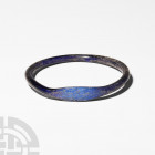 Sidonian Glass Bracelet Circa 1st century A.D. A dark blue glass annular bracelet composed of a round-section hoop and expanded bezel. 15.6 grams, 79 ...