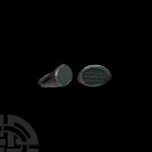 Persian Silver Ring with Calligraphic Gemstone 12th-13th century A.D. A silver finger ring with ellipsoid bezel, inset aventurine cloison with engrave...