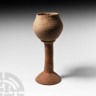Bactrian Terracotta Chalice 3rd millennium B.C. A terracotta chalice composed of a tulip-shaped bowl, cylindrical stem and domed foot. Cf. Cavallini, ...