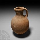 Bronze Age Holy Land Jar 3rd-2nd millennium B.C. A ceramic jar with globular body, trumpet-shaped mouth with pouring lip, strap handle to the rear. 95...