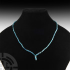 Achaemenid Turquoise Bead Necklace Circa 4th century B.C. and later. A restrung necklace composed of opaque and transparent blue glass beads of variou...