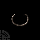 Western Asiatic Twisted Bar Bracelet 1st millennium A.D. A silver penannular bracelet composed of three entwined, twisted wire bars with tapering term...