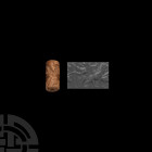 Early Dynastic Cylinder Seal with Lion and Lamassu 3rd millennium B.C. A cylinder seal with a standing figure facing a lion with its jaws open, facing...