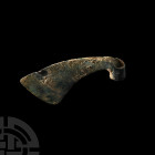 Luristan Votive Axehead 13th-7th century B.C. A copper-alloy votive axehead with curved upper and lower edges and convex cutting edge, tubular socket....
