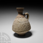 North African Terracotta Jug with Handles 9th-10th century A.D. A carinated ceramic jug with strap handle and small plinth foot; frieze of stylised pl...