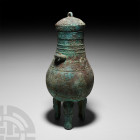 Chinese Archaic Style Tripod Vessel 20th century A.D. or earlier. An archaistic hu style vessel with piriform body, two lug handles, domed lid with su...
