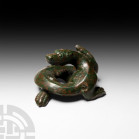 Chinese Dragon Weight 19th-20th century A.D. A Han style bronze weight in the form of a dragon with a coiled, snake-like body, powerful clawed paws an...
