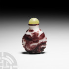 Chinese Snuff Bottle with Fenghuangs 20th century A.D. A glass flask-shaped snuff bottle with purple fenghuangs amongst clouds against a white ground,...