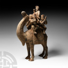 Chinese Style Camel and Musician Figurine 20th century A.D. A base metal figurine of a camel with saddlecloth and gilt detailing, four outward-facing ...